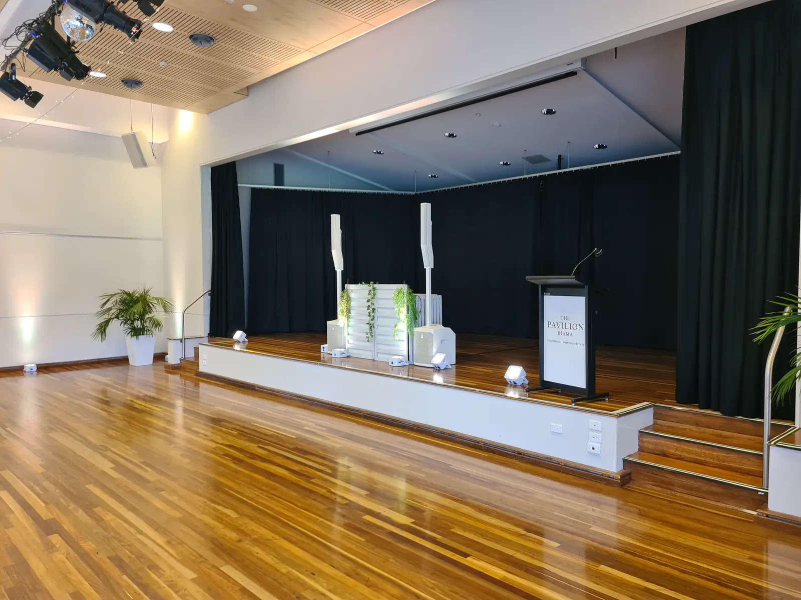 Ultimate DJs booth, column speakers and uplights set up on stage at Pavilion Kiama