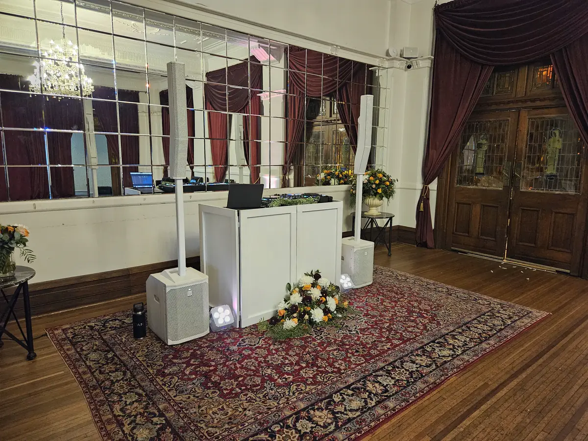 Ultimate DJs Signature white DJ booth with uplights at the Robertson Hotel