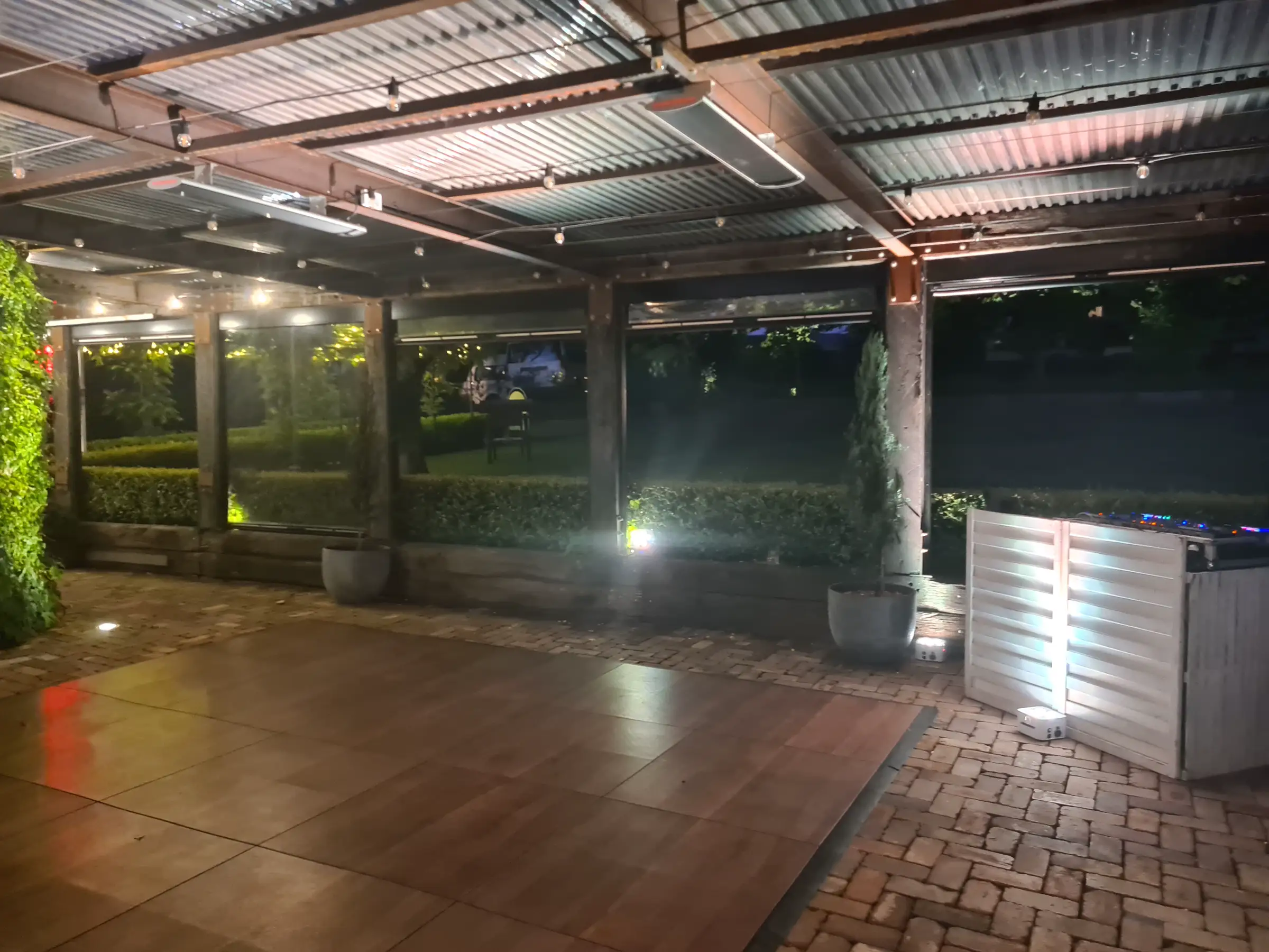 Lit outdoor dance floor and DJ booth ready for a wedding reception at The Homestead in Berry