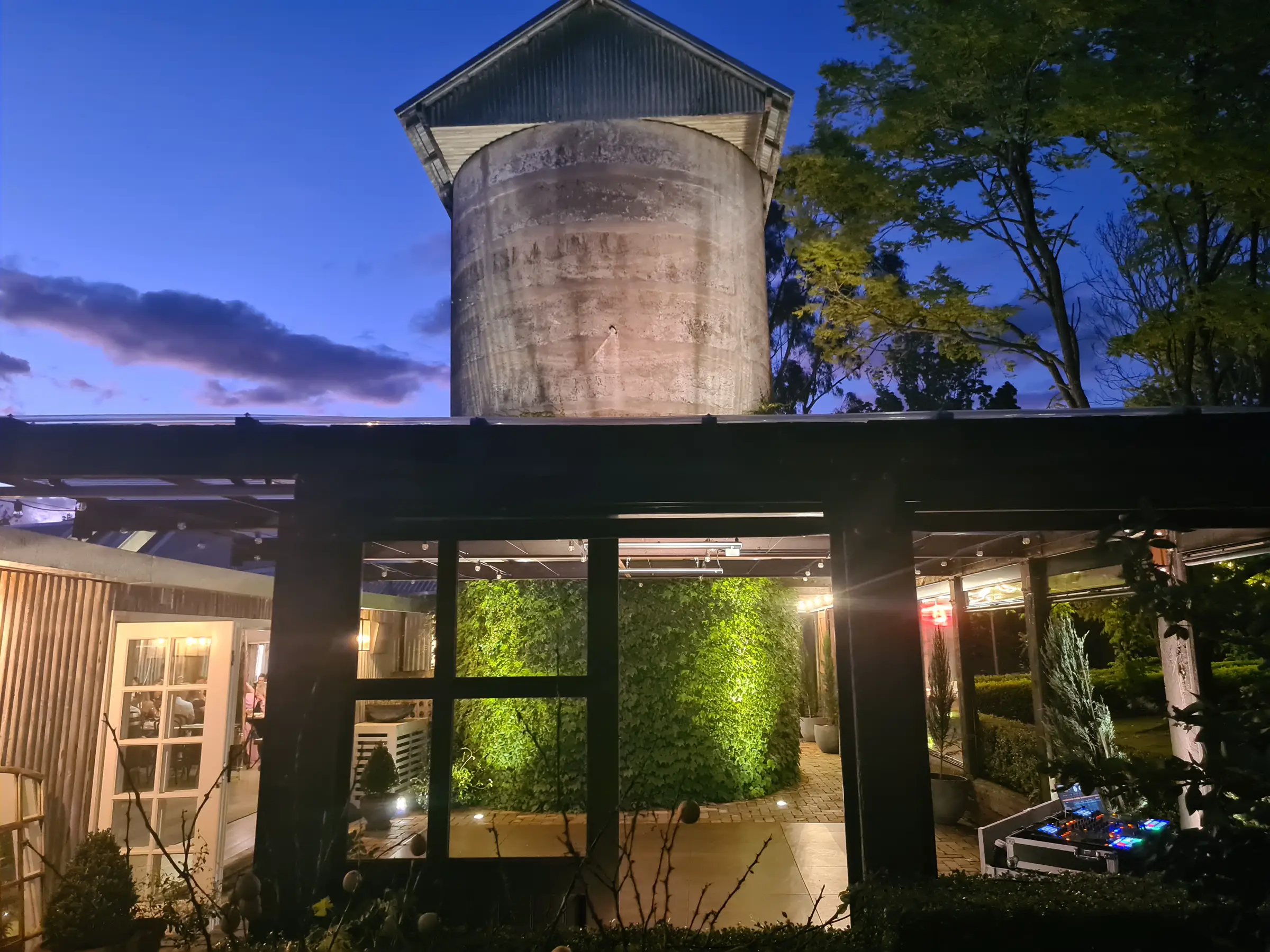 The Homestead in Berry at dusk with an Ultimate DJs setup on the patio