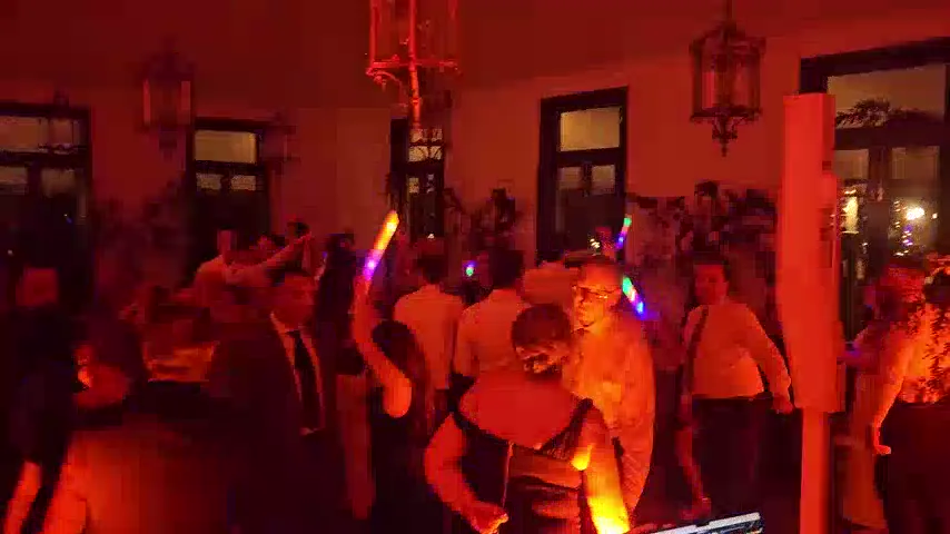 Guests dancing with glow sticks at a Jaspers Berry wedding reception