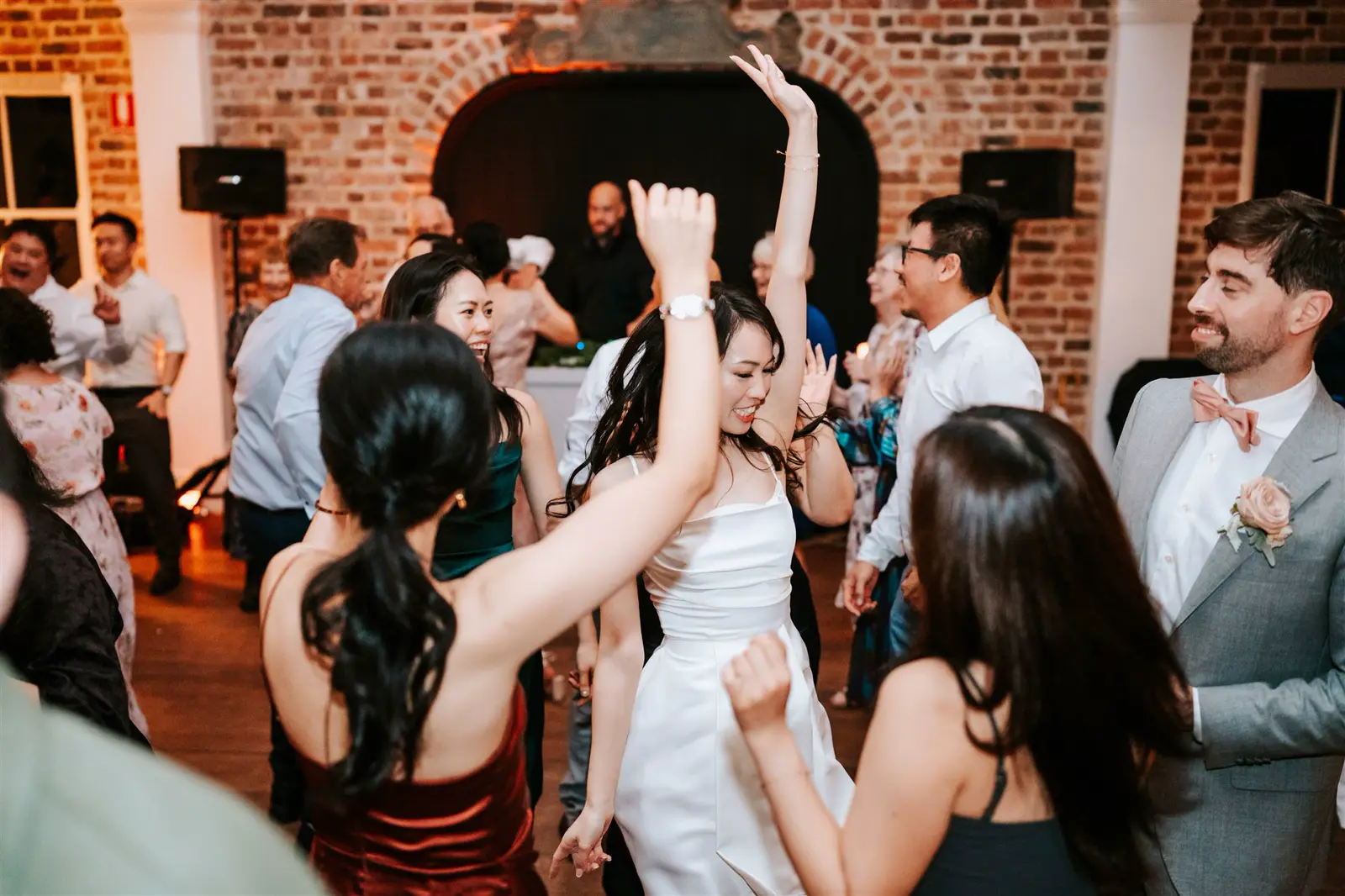 Bride and wedding guests singing and dancing together at Montrose House