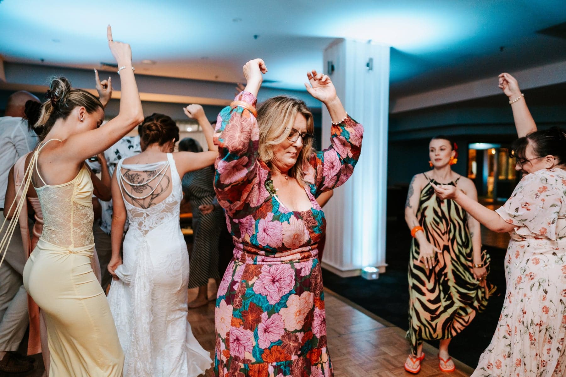 Wedding guests dancing with their hands in the air at Jesse and Evie’s Sebel Kiama reception
