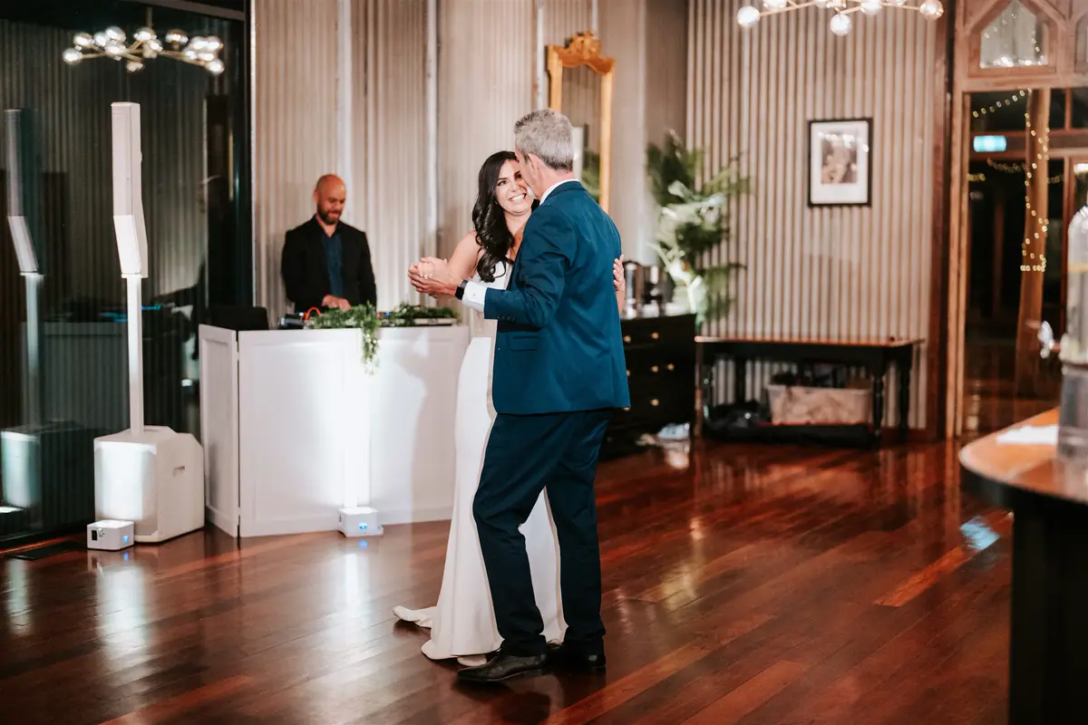 Bride dancing in front of the Ultimate DJs booth at a Mali Brae Farm wedding