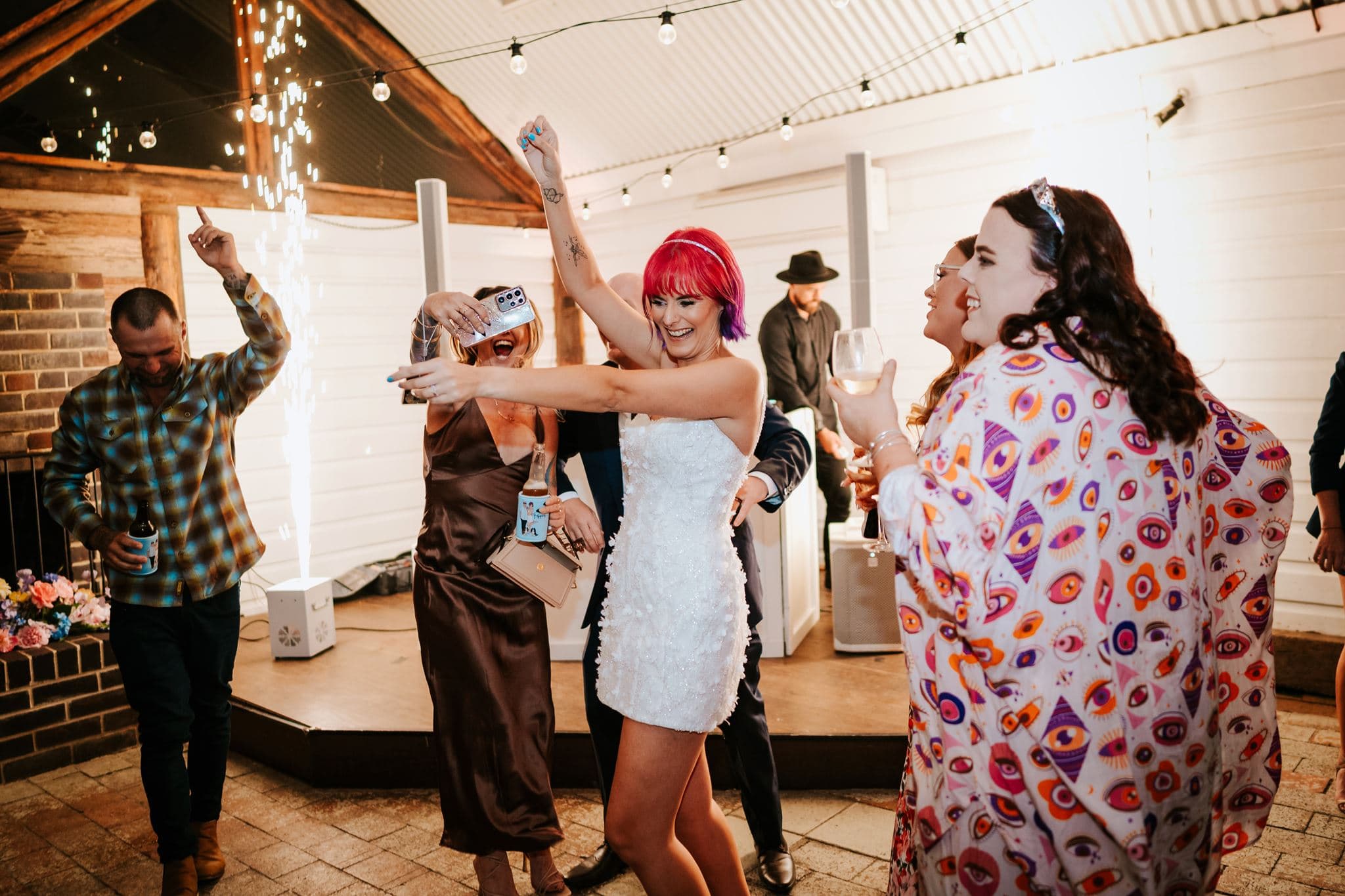 Wedding guests celebrating beside a Sparkular fountain on the dancefloor at Robertson Public House