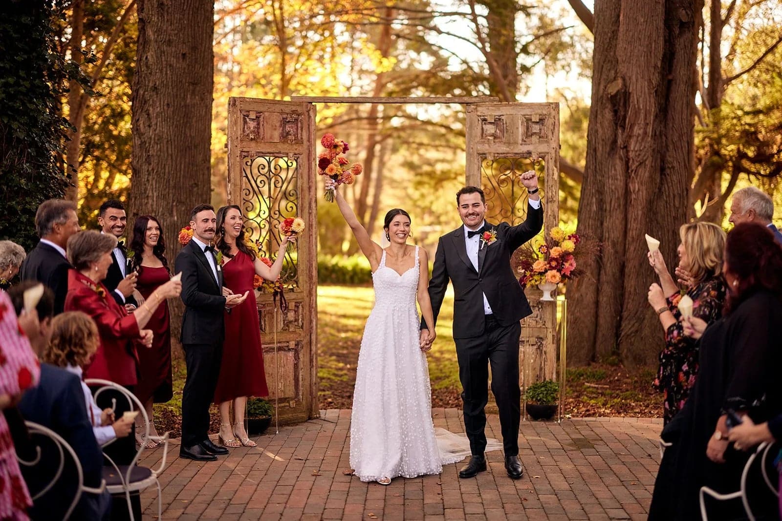 Phil and Caela during their outdoor wedding ceremony surrounded by guests at Montrose House