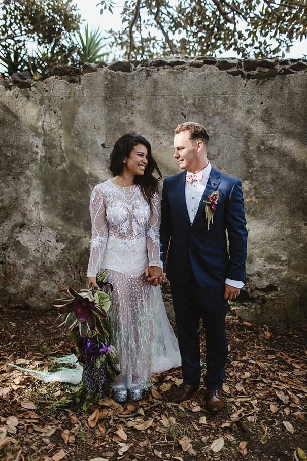 Ange and Brent holding hands in their wedding outfits at Bushbank
