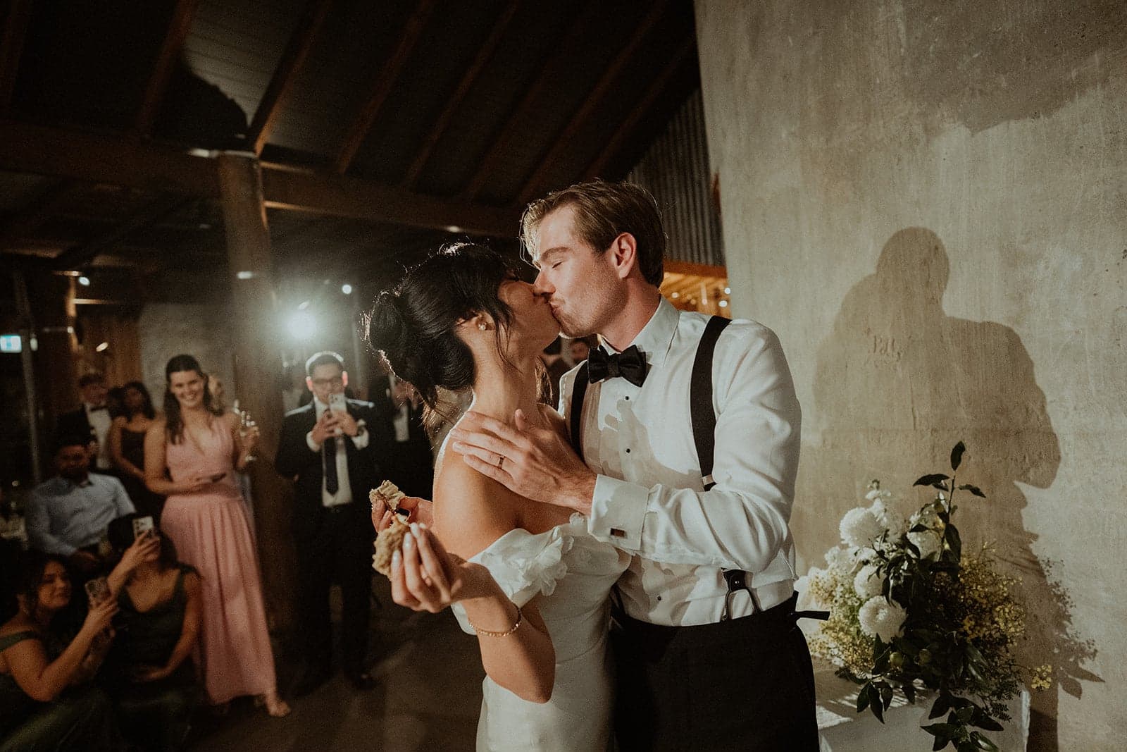 Stephanie and James sharing a kiss at their Greyleigh Kiama reception