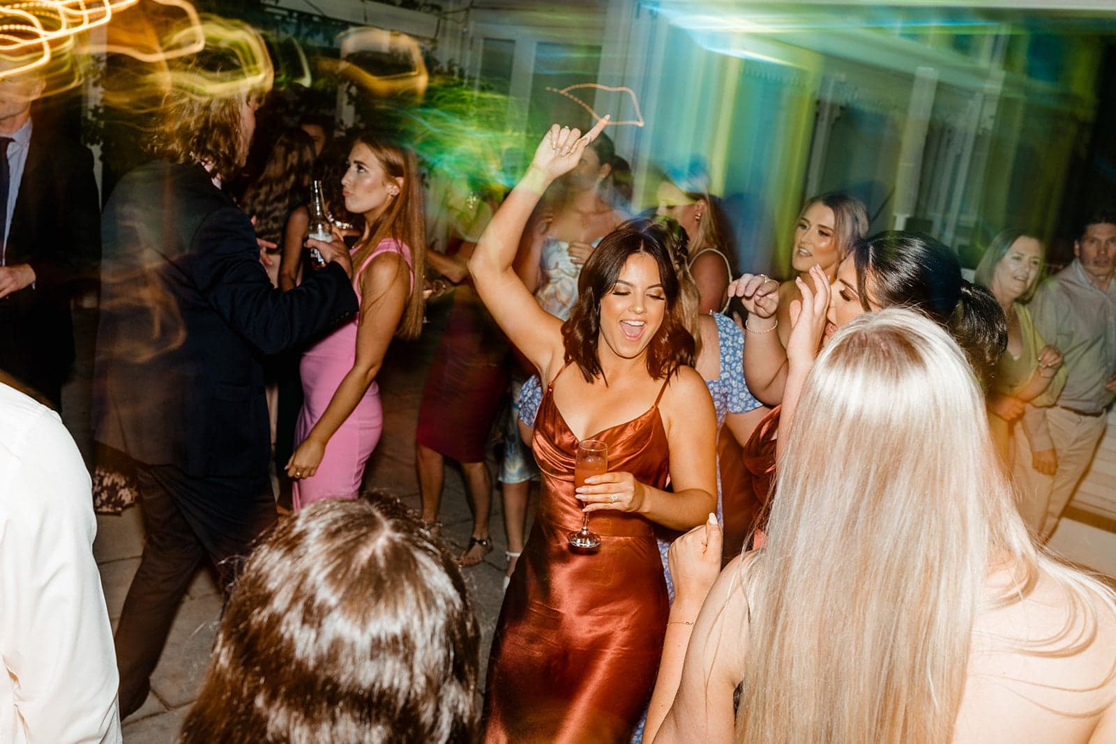 Wedding guests dancing with their hands up at William and Mikayla’s Ravensthorpe Estate reception