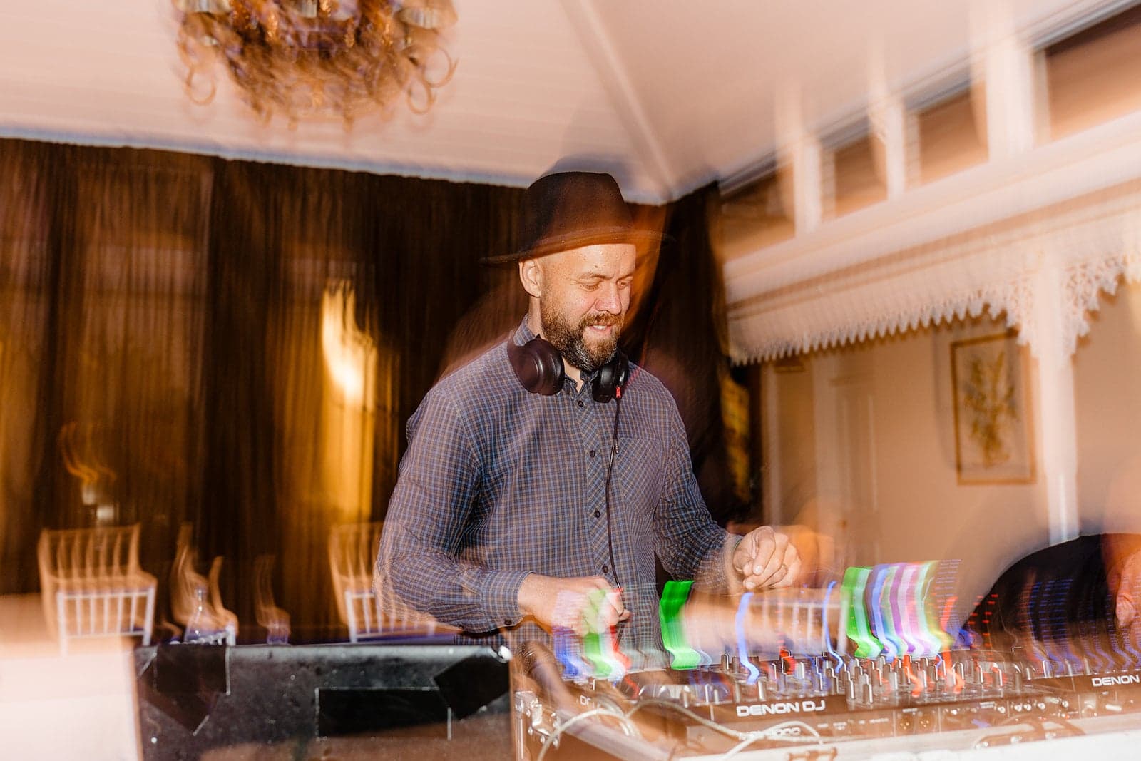 The wedding DJ mixing behind the decks at William and Mikayla’s reception
