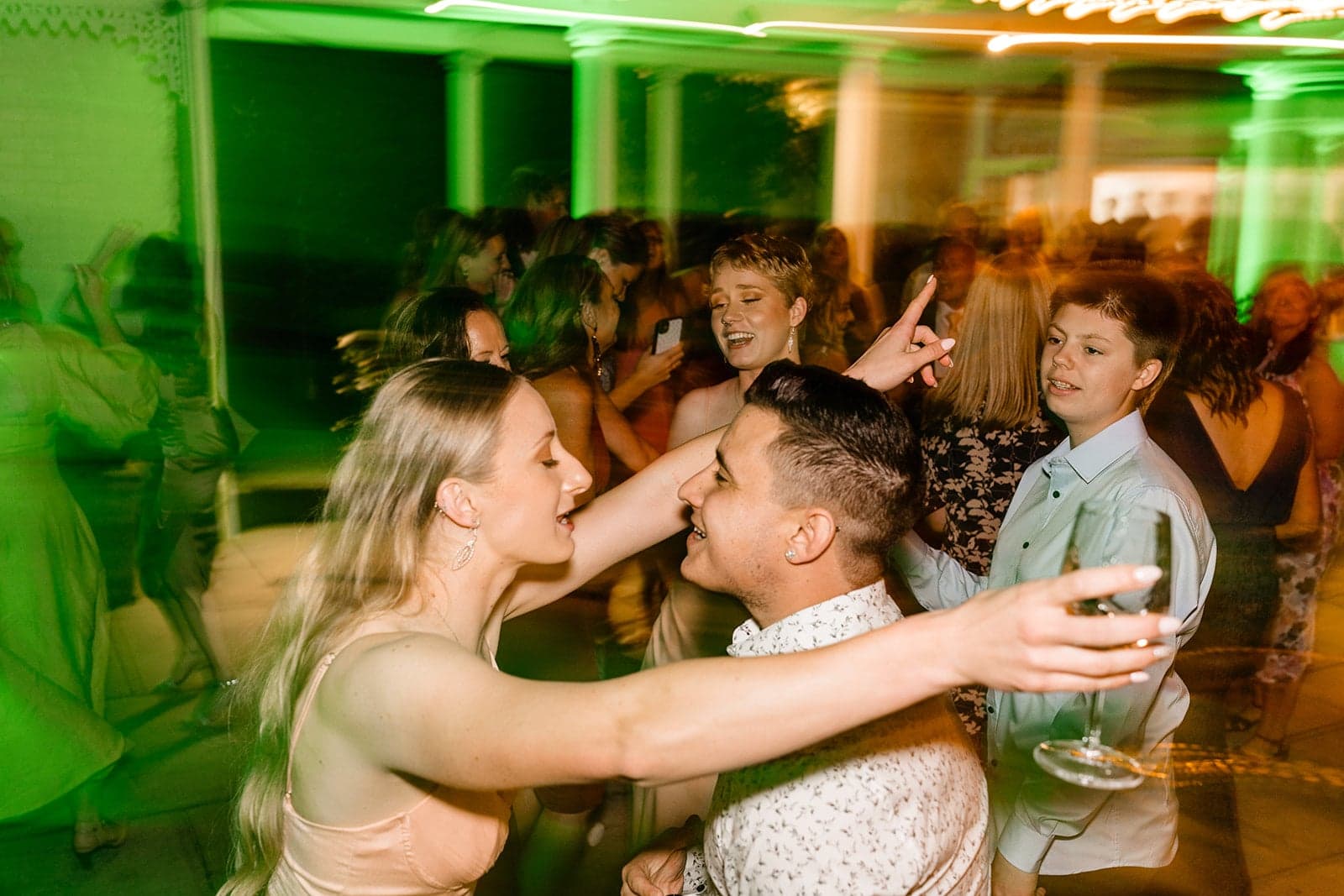 Friends and family dancing together under colourful lights at Ravensthorpe Estate