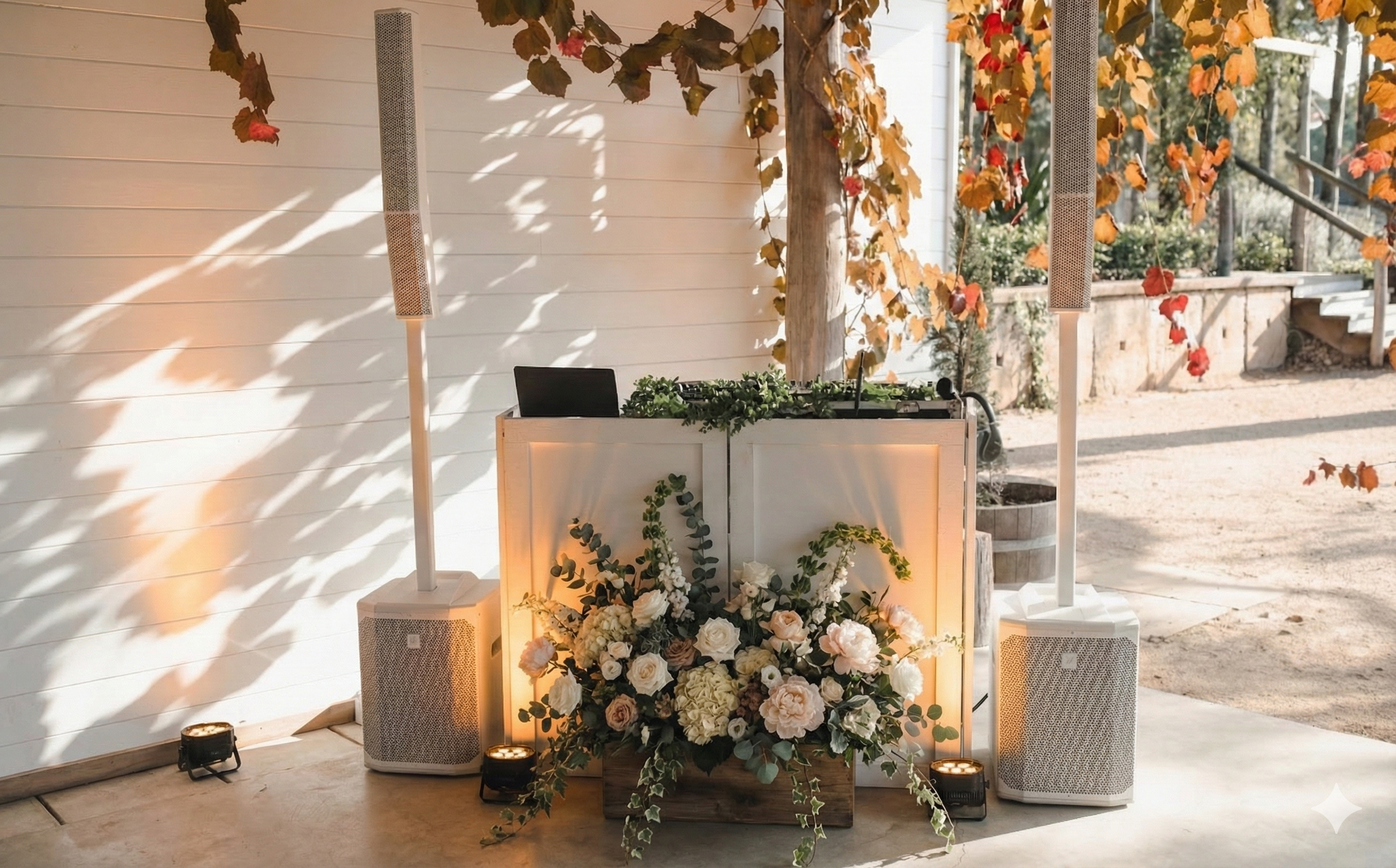 Signature white wedding DJ booth and column speakers